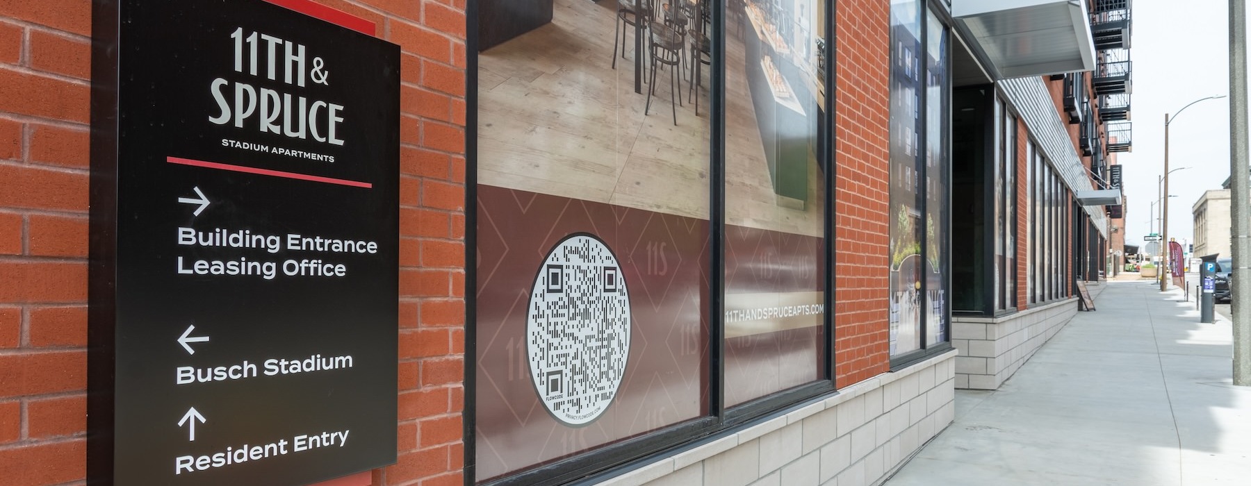 Exterior building sign for 11th & Spruce apartment rentals in St. Louis, MO.