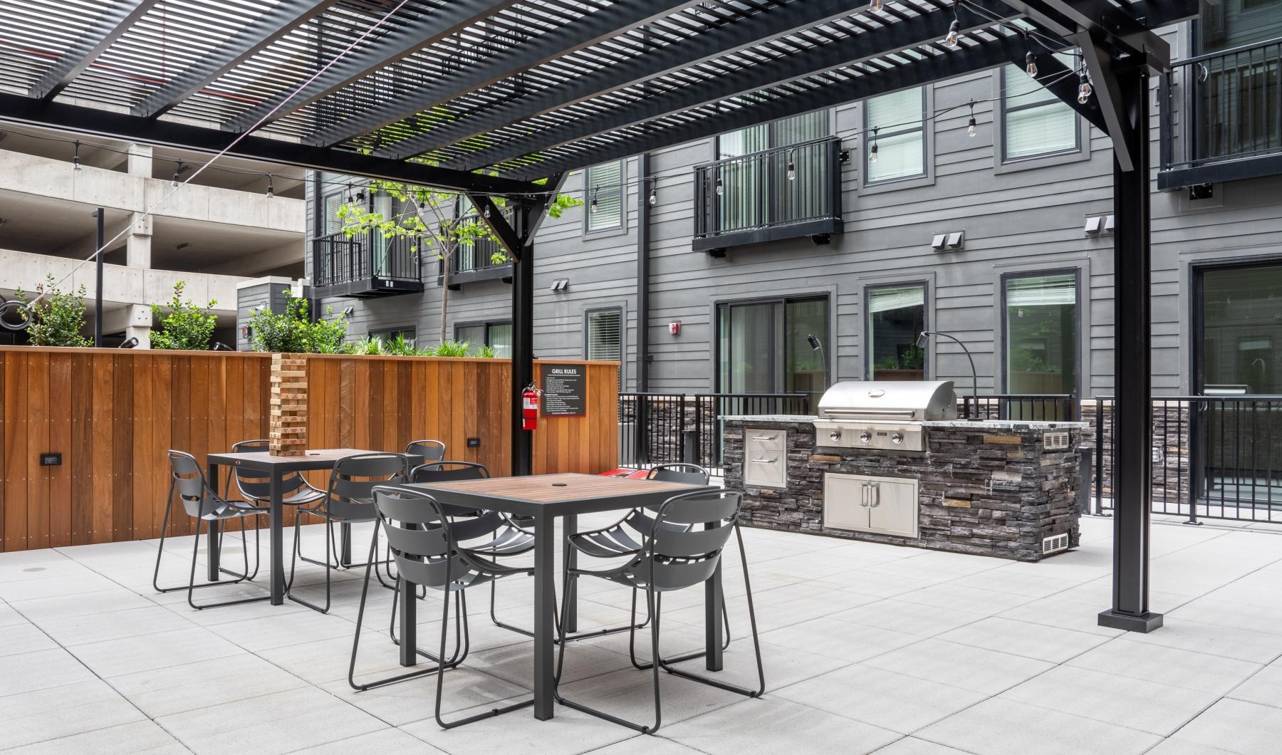 a grill table and chairs outside a building