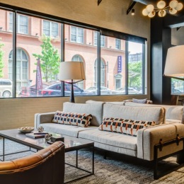 a lounge with a couch and chairs