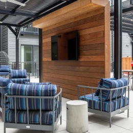 a patio with tv chairs and tables